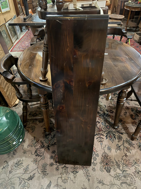 Round, dark wood dining table